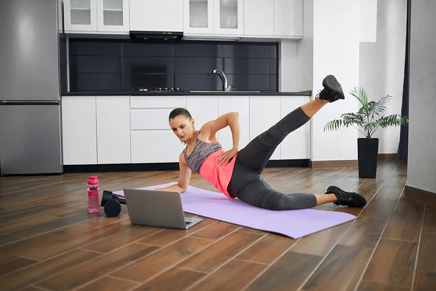 Woman doing yoga stretch on mat