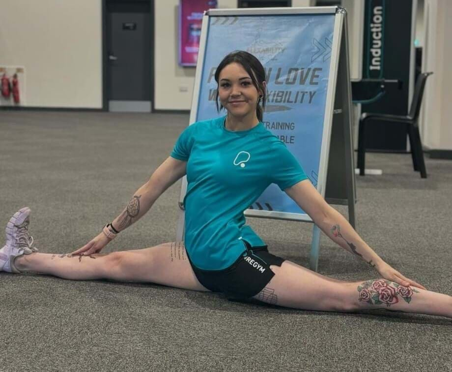 Woman in split position at gym