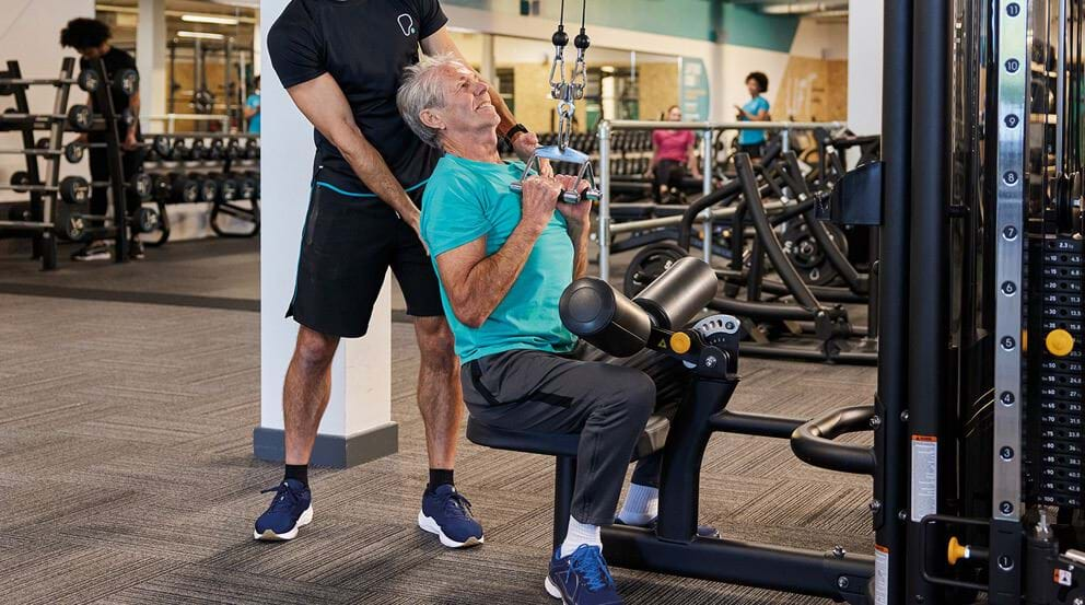 Senior using resistance training equipment