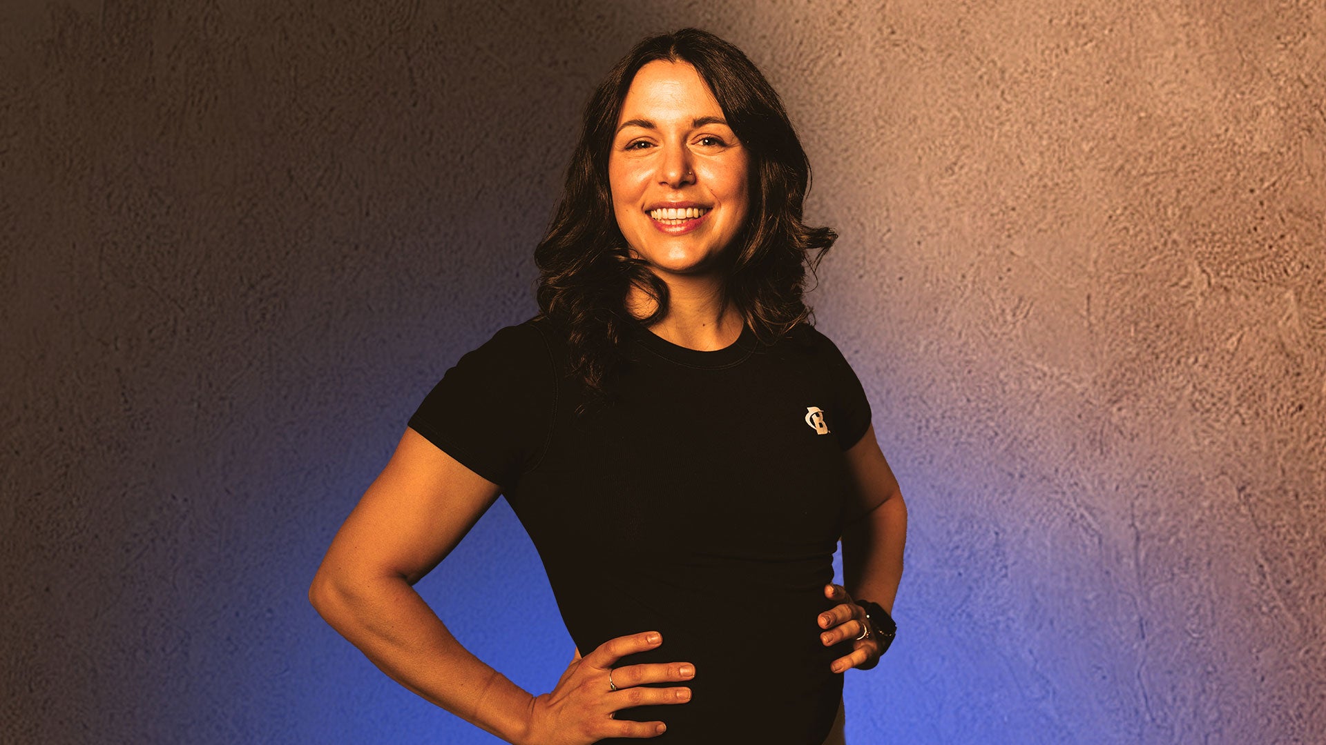 Woman smiling in black tee headshot