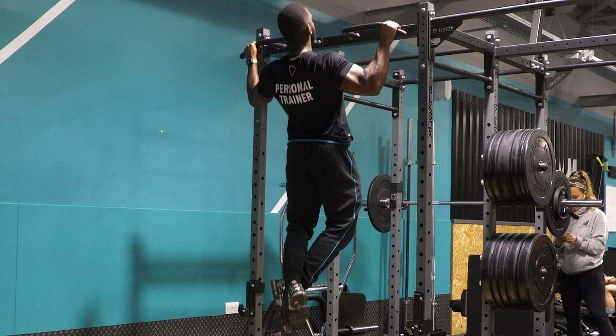 Man performs pull-up exercise