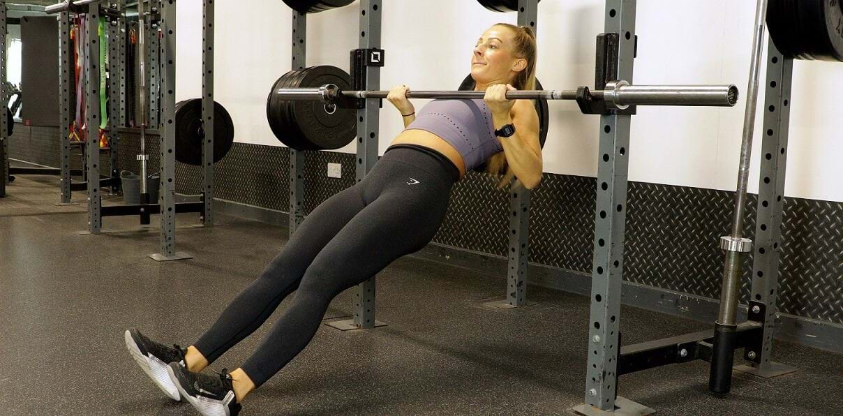 Woman doing inverted rows