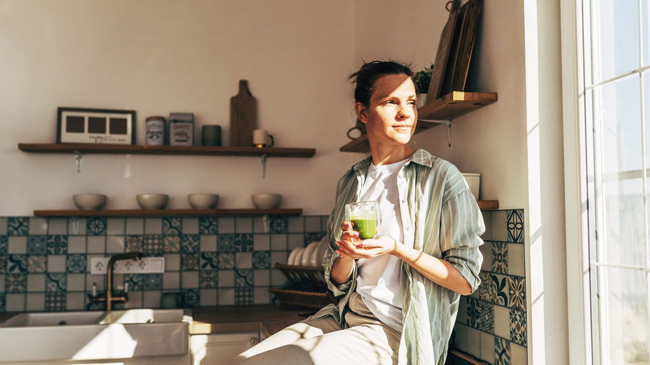 Woman drinking green smoothie