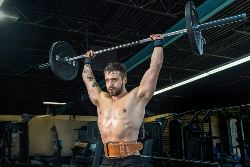 Man performing overhead barbell press