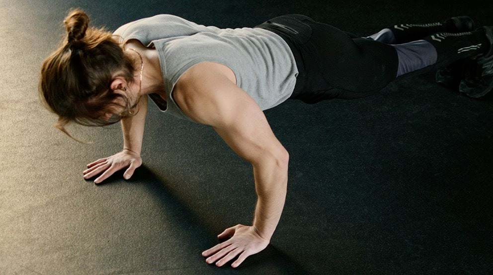 Woman performing calisthenics shoulder exercise