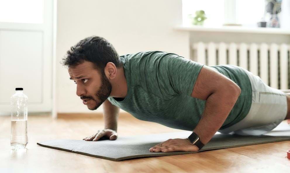 Man exercising on purple mat