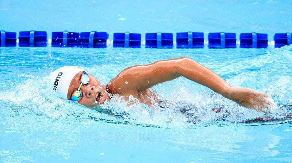 Swimmer training in indoor pool