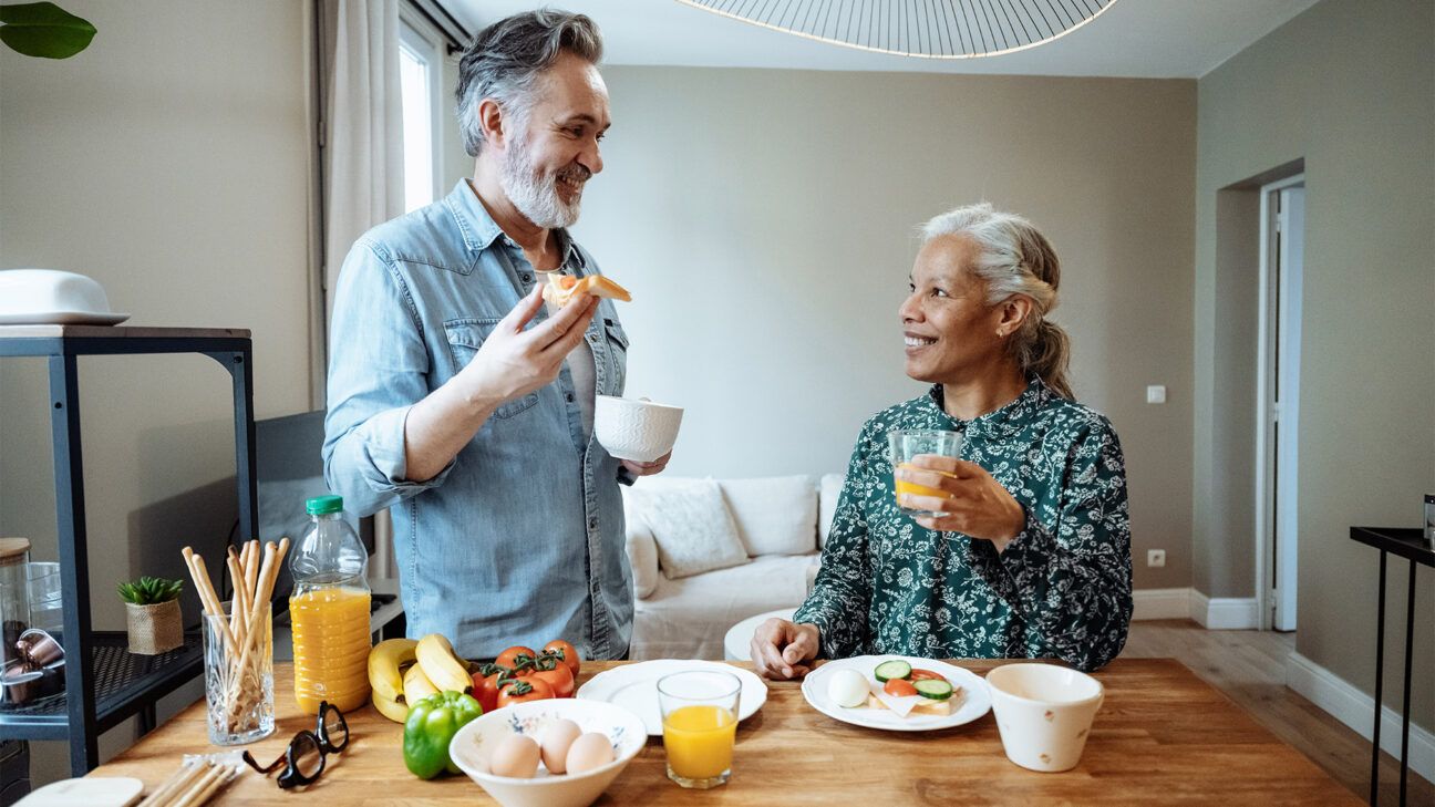 Couple smiling at breakfast table