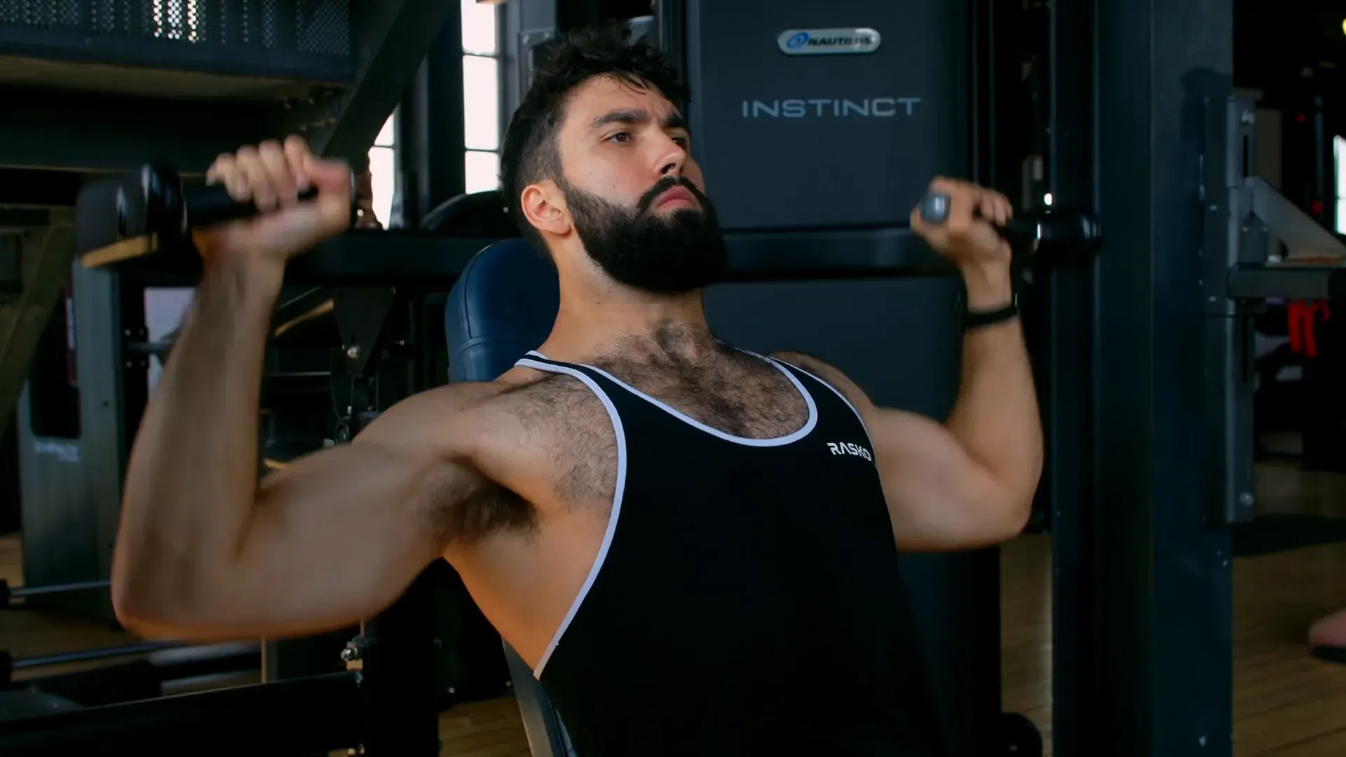 Muscular man lifting dumbbells