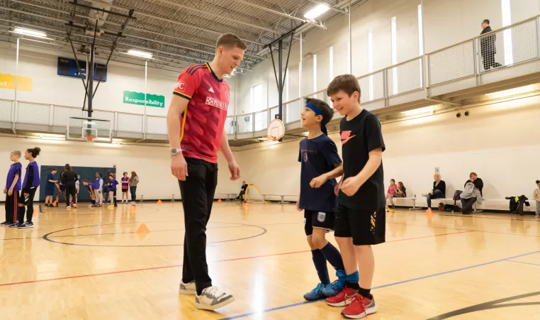 Coach training boys in gym