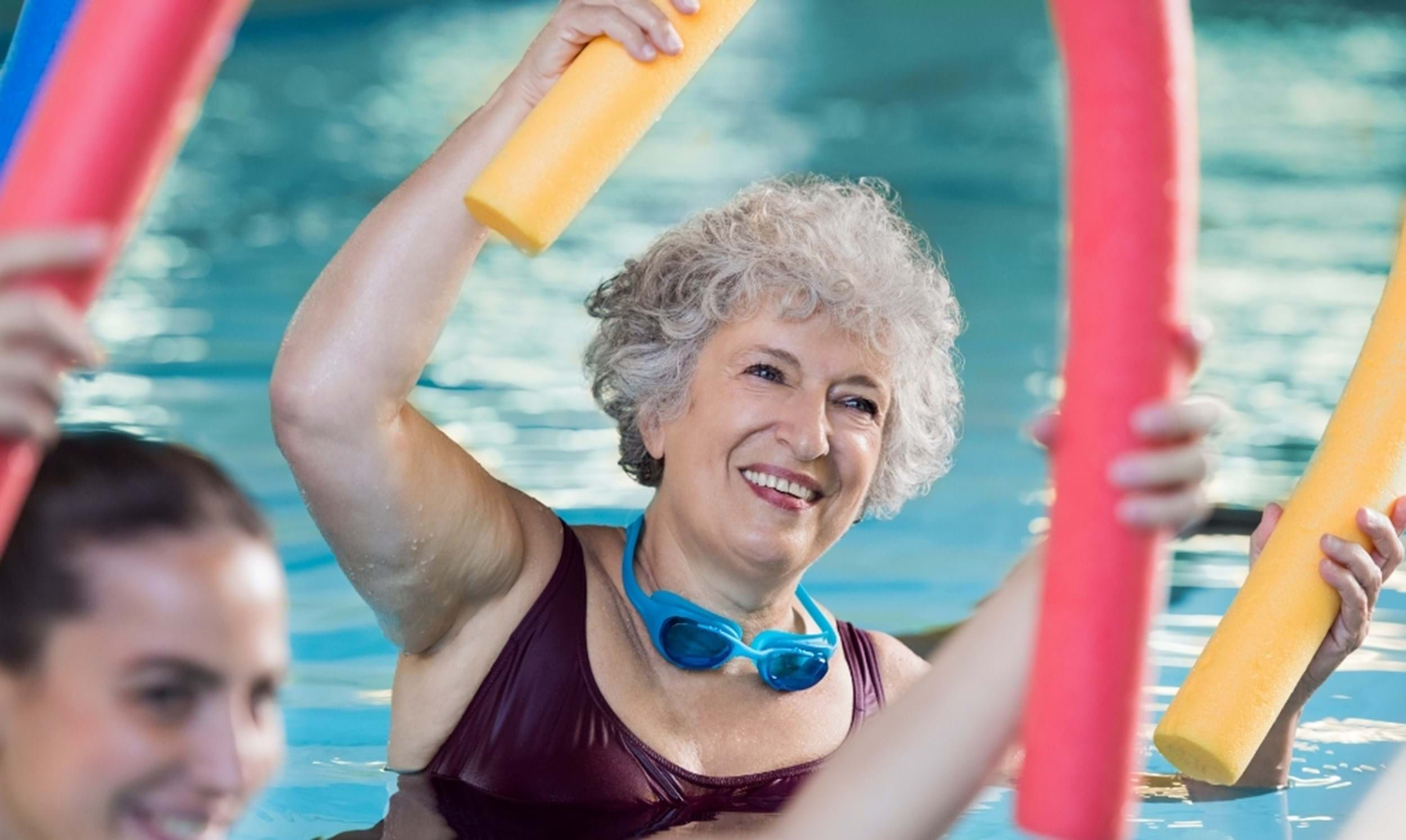 elderly woman exercising in pool