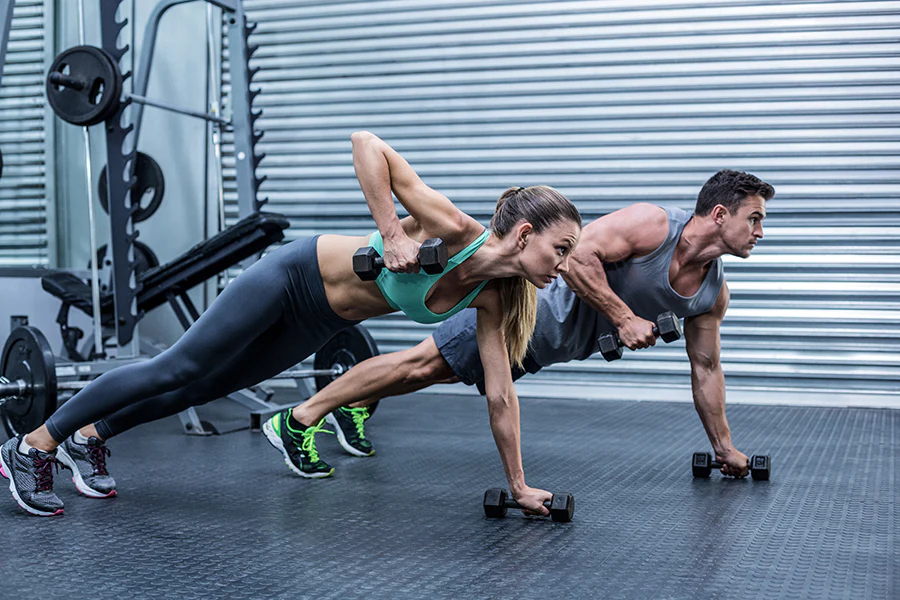 Muscular people exercising in gym