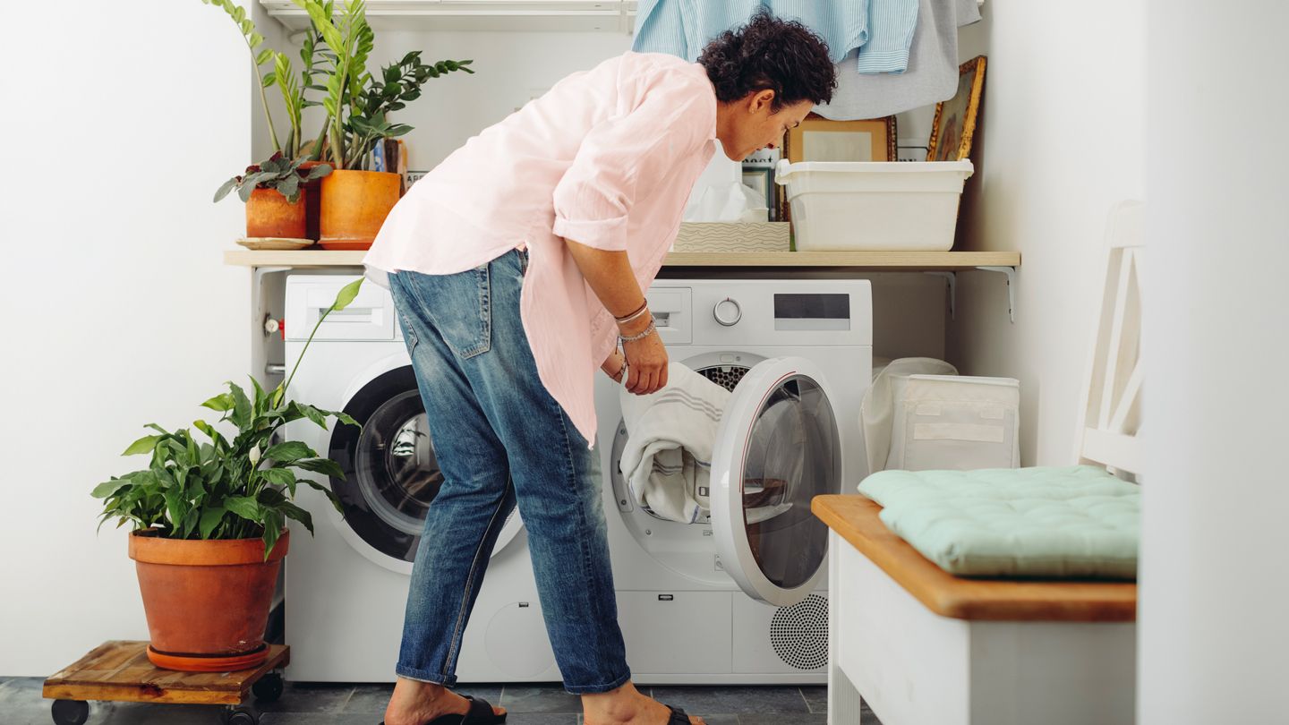 Woman loading laundry for eczema care