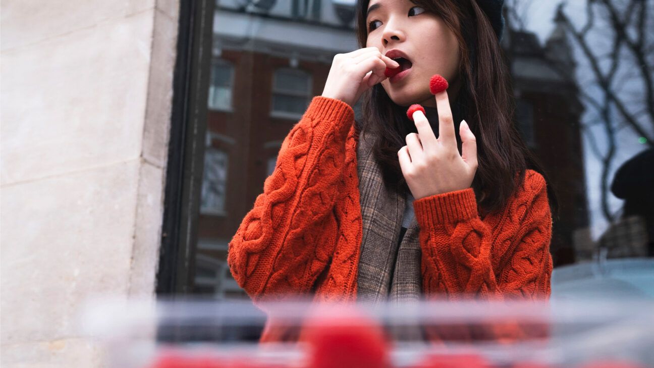 Woman eating fresh berries outside