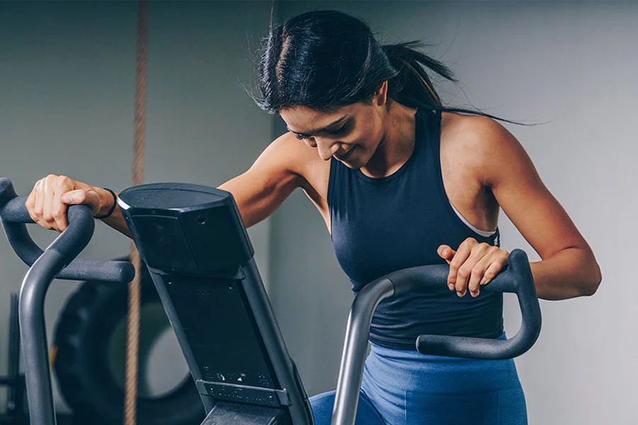 Woman exercising on elliptical trainer