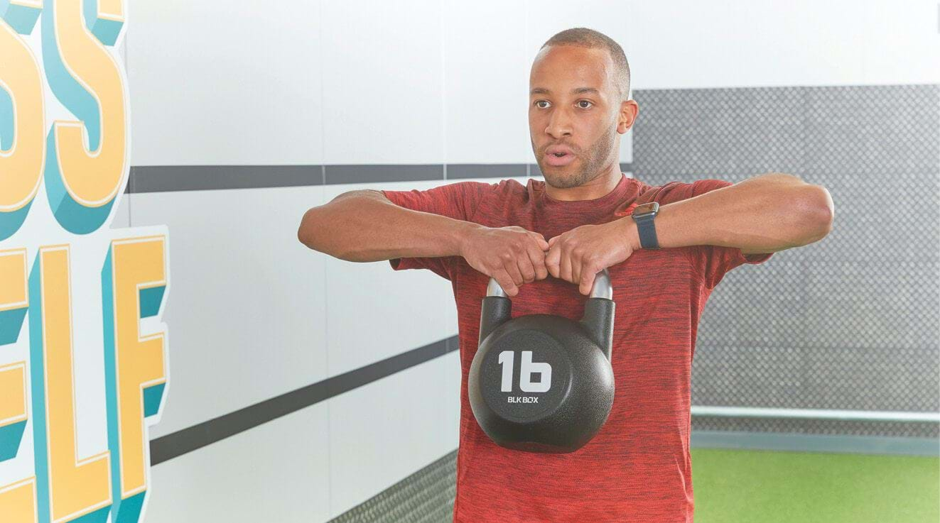 Man performs HIIT kettlebell exercise