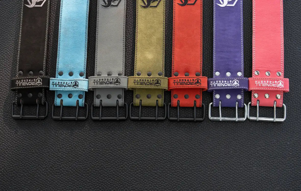 Seven weightlifting belts displayed in line