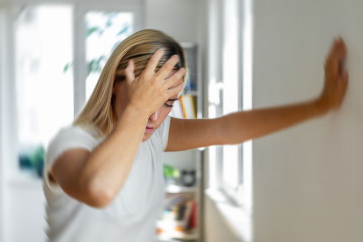 Woman clutching chest in distress