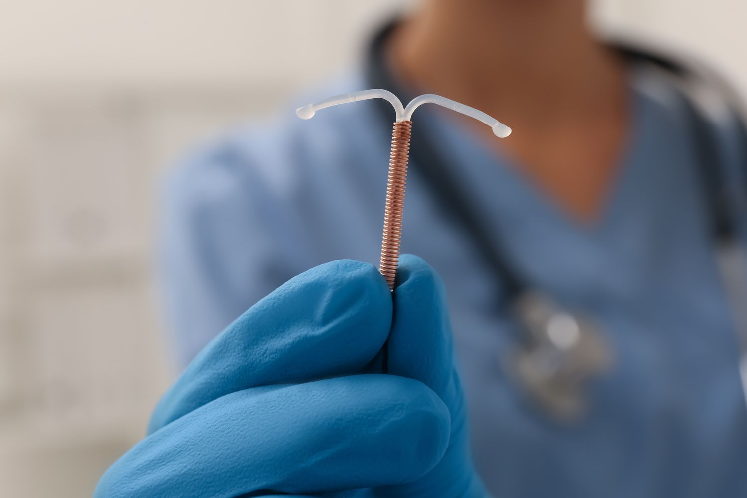 Doctor displays IUD birth control device