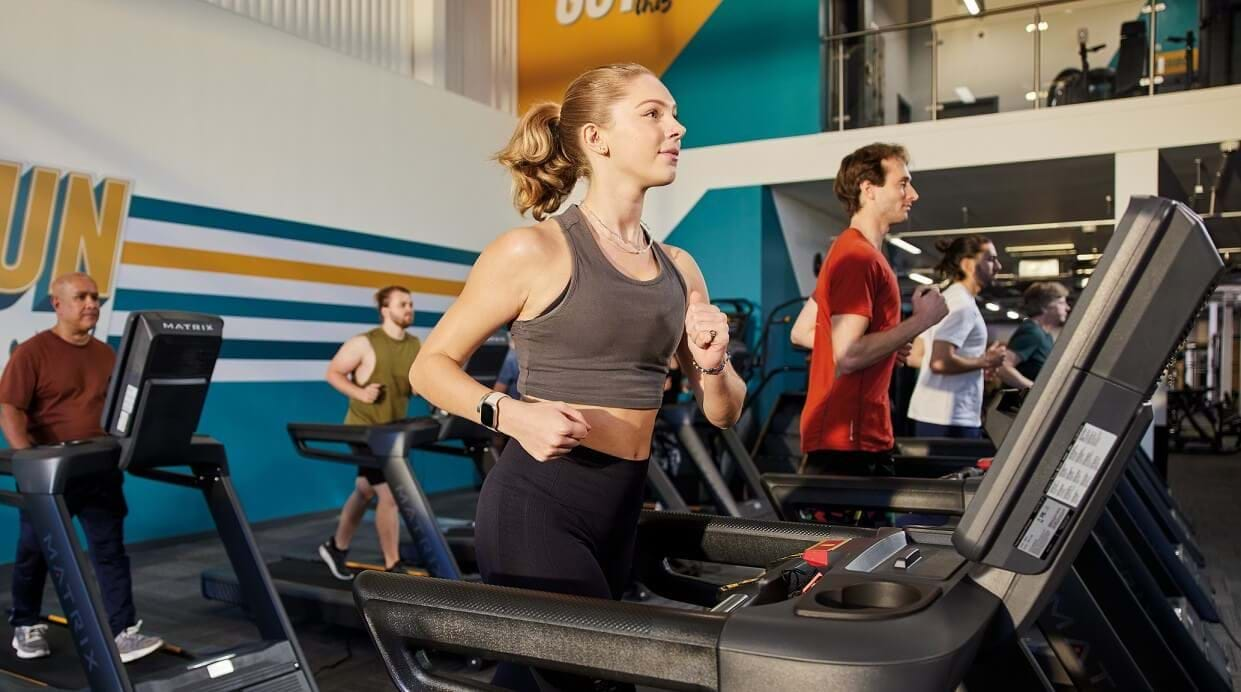 Woman jogging on gym treadmill