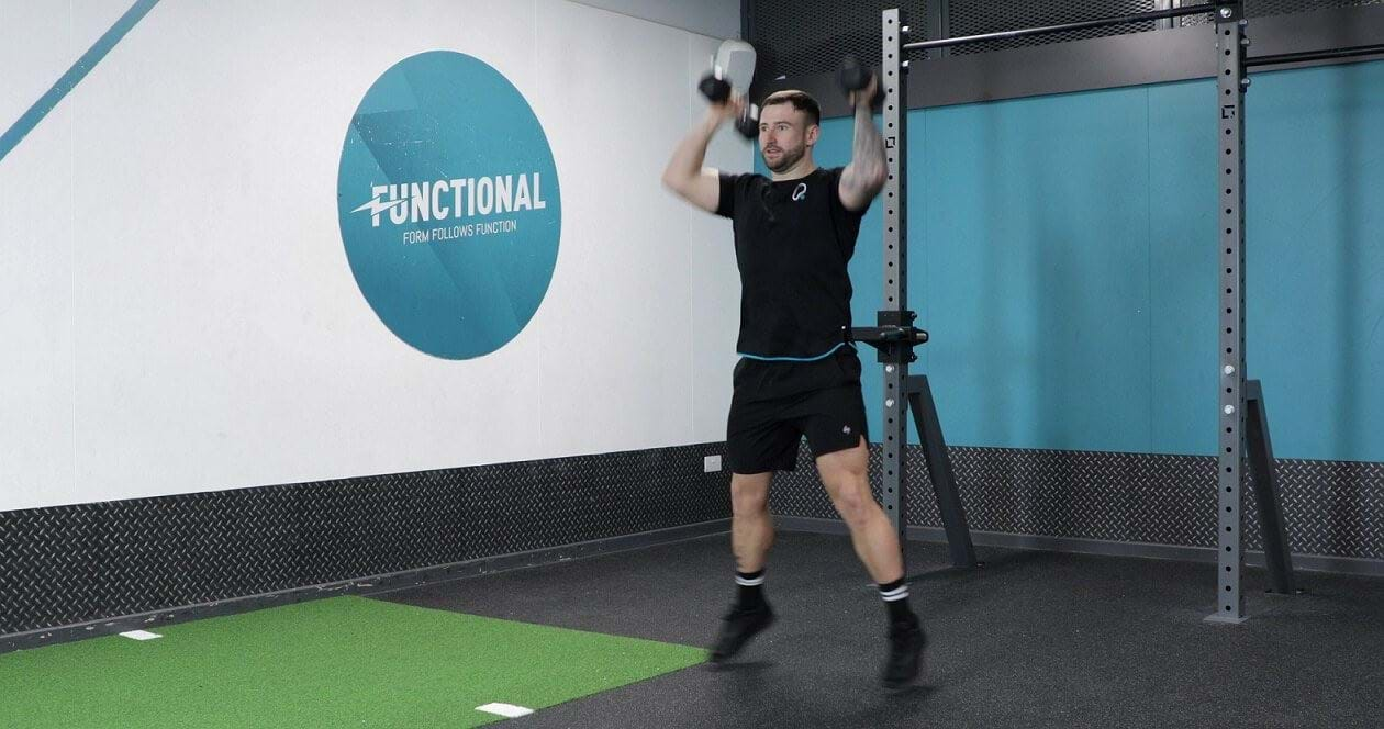 Man performing dumbbell press jacks