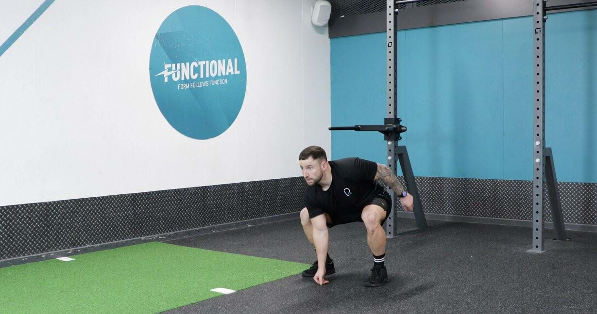 Man performing squat jack exercise