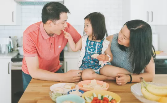 Family preparing healthy kids snacks