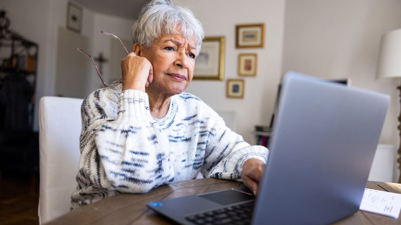 Frustrated older woman at laptop