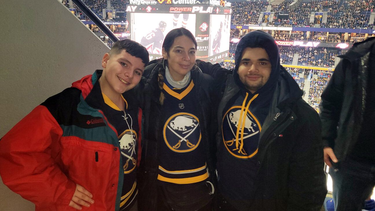 Three Sabres fans in jerseys