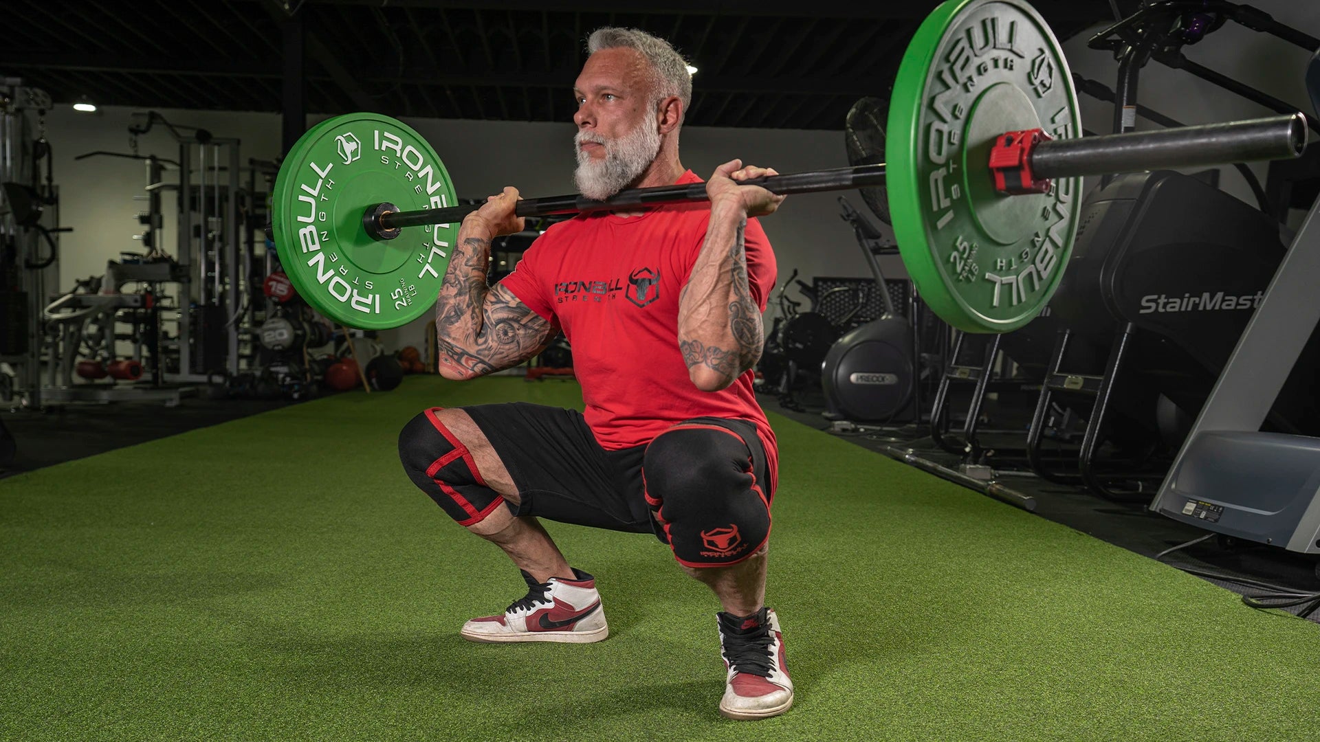 Man squatting with knee sleeves