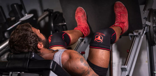 Man squatting with knee sleeves