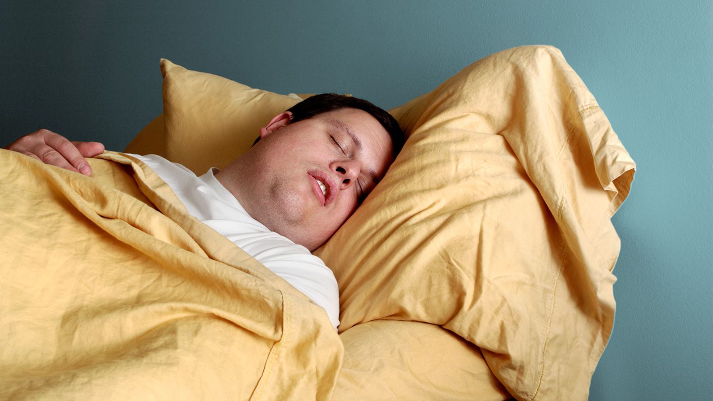 Man snoring while sleeping on pillow