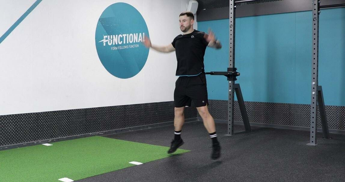 Man performing jumping jacks exercise