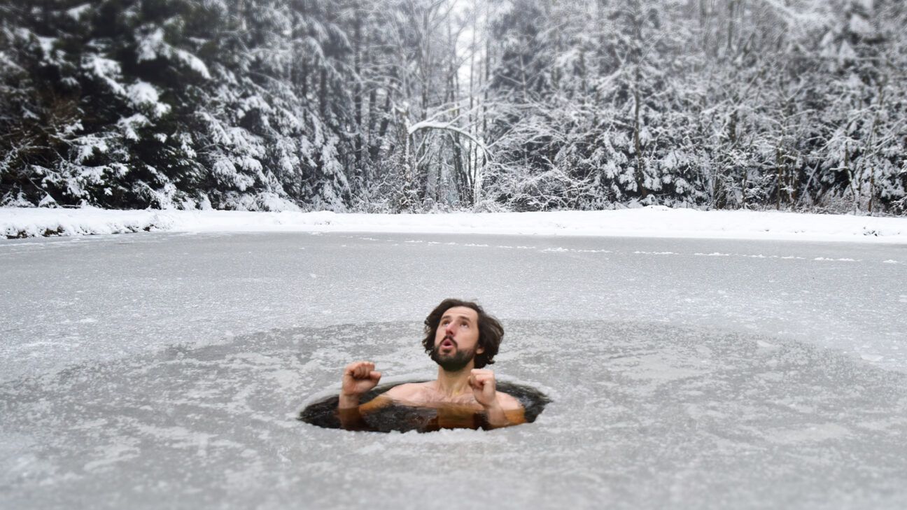 Man taking cold plunge outdoors