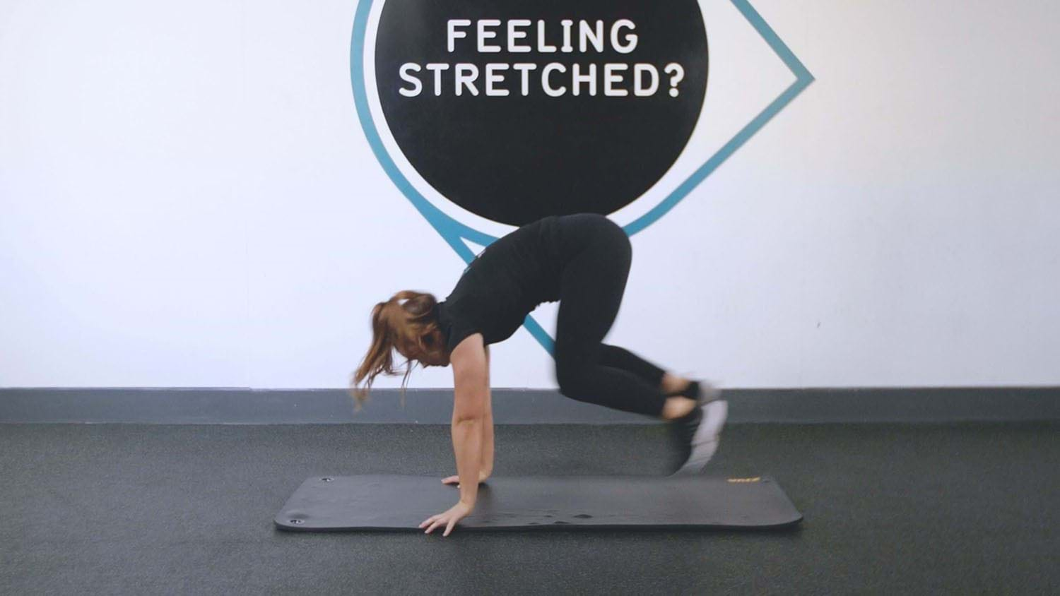 Woman performs burpee exercise