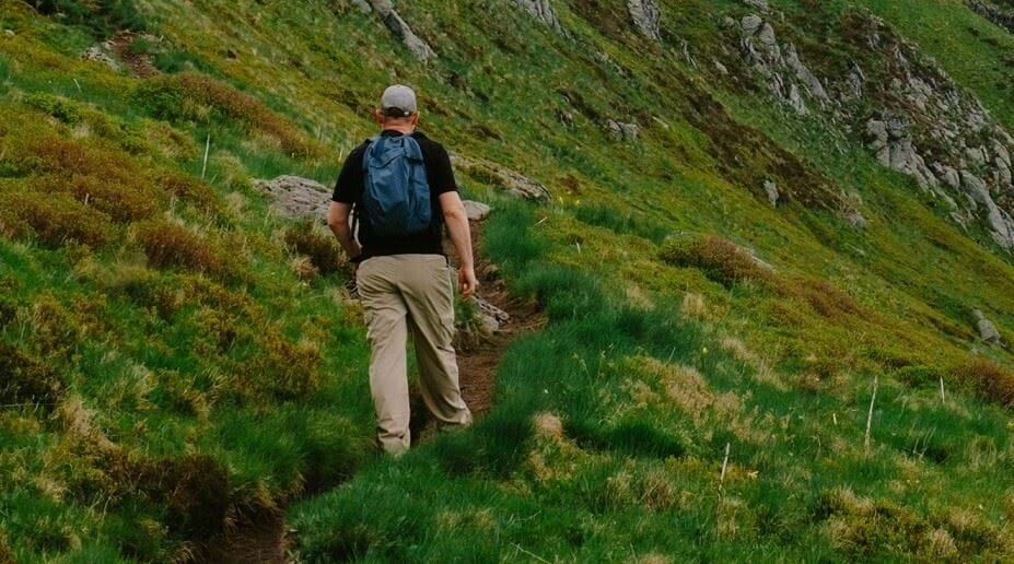 Person walking uphill on trail