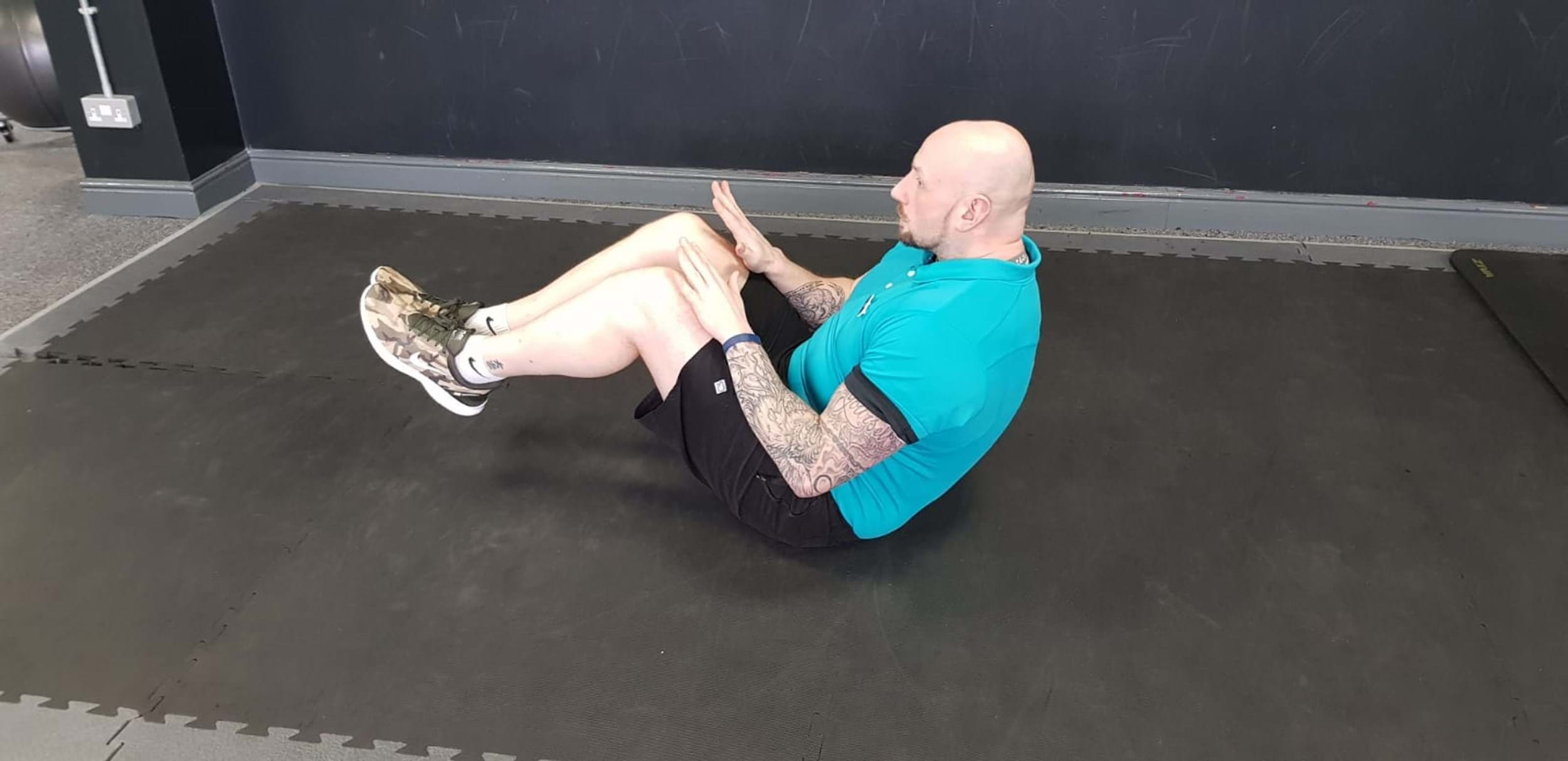 Man doing double crunch exercise