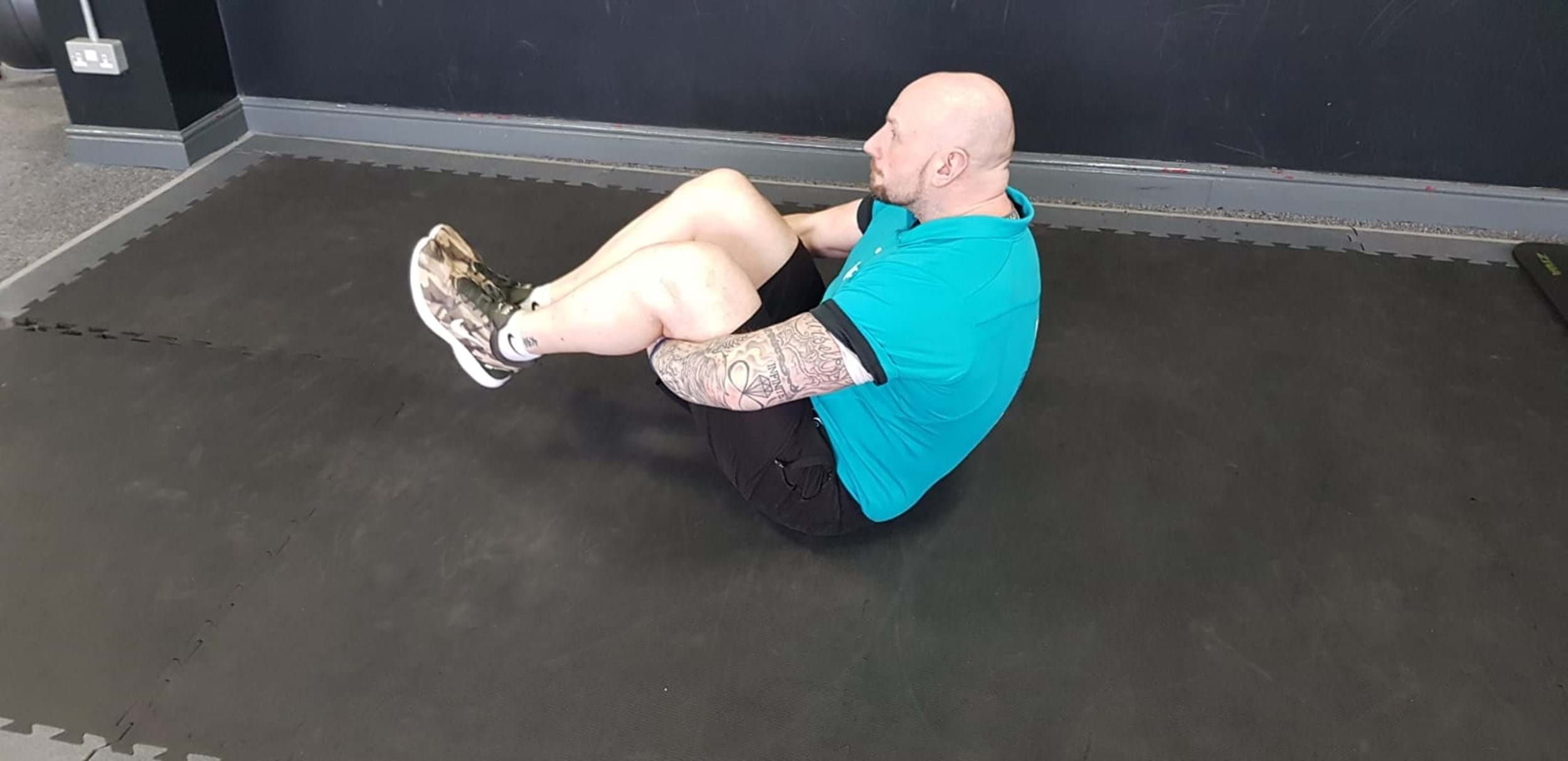 Man performing angel clap sit-up