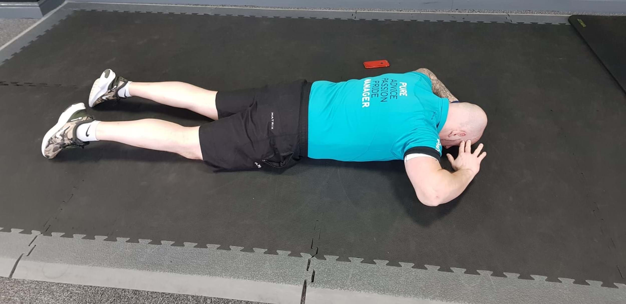 Man in plank on gym floor