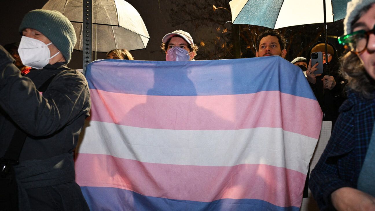 Protesters holding transgender pride flags