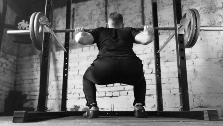 Man doing barbell squat