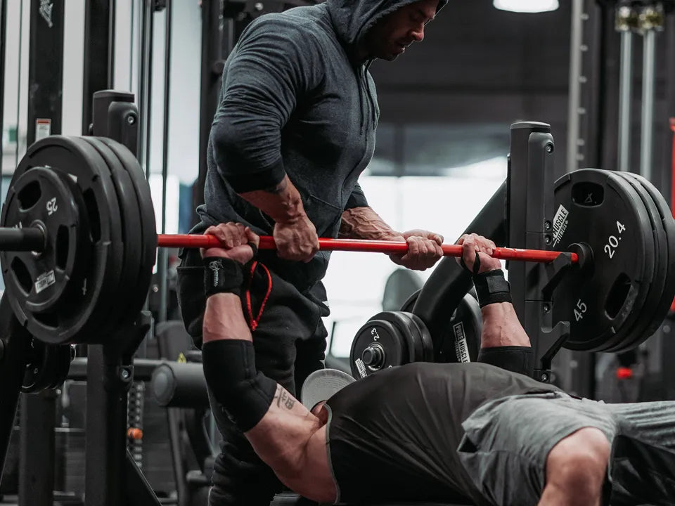 Man bench pressing with wrist wraps