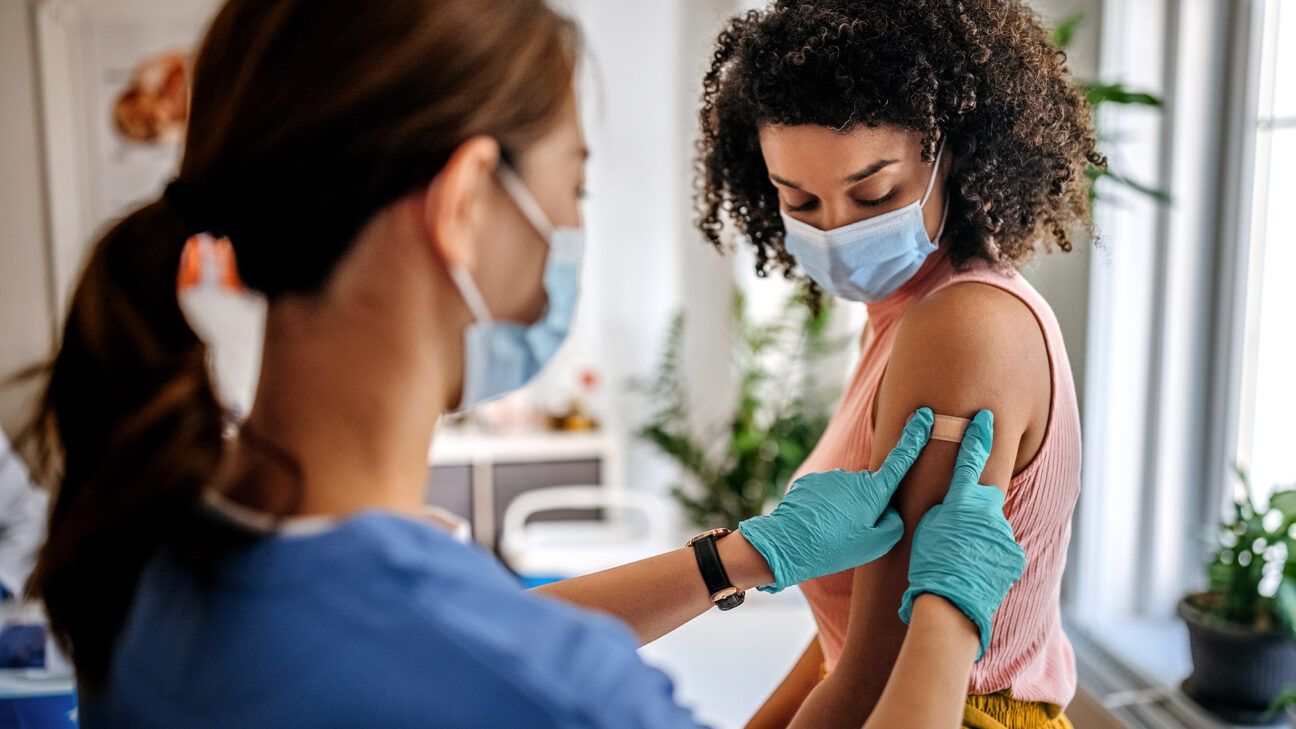 Woman getting arm vaccination shot