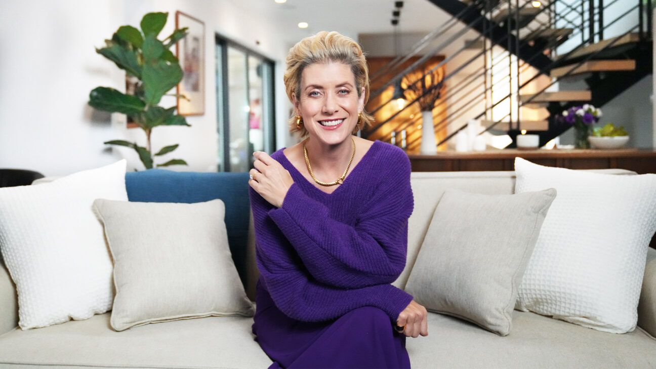 Woman relaxing on living room couch