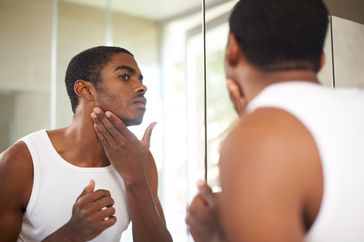 Man gazing at mirror reflection