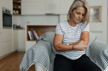 Woman grimacing with elbow pain