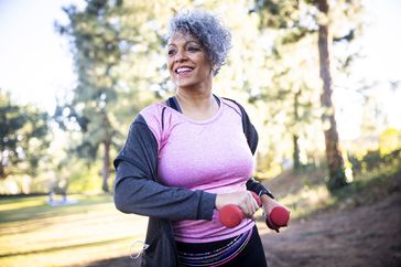 Woman exercising with red weights