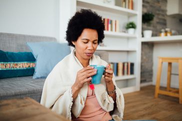 Woman sips herbal tea for anxiety