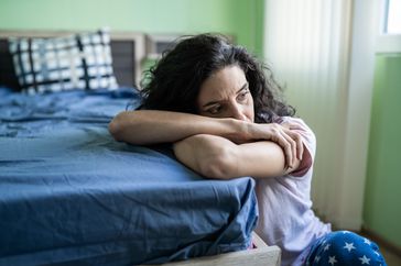 Woman alone on floor looking distressed