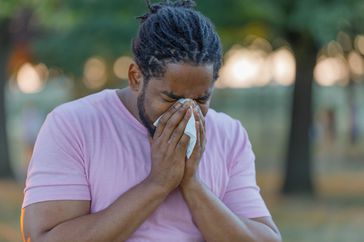 Man with stuffy nose using tissue